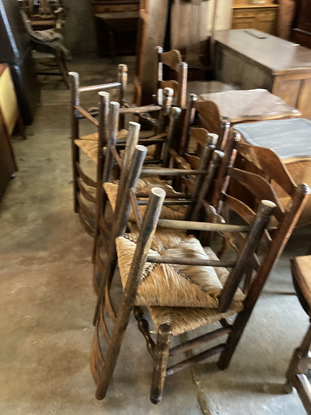 A set of eight rush seat ladderback dining chairs (two with arms)